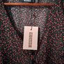 Missguided dress features a ditsy floral print on a black background with button detailing. New with Tags. Image 5
