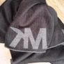 Authentic Michael Kors reversible knit scarf in charcoal black/heather grey with oversized MK logo detail. Image 8