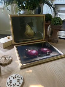 Two gold framed fruit prints.