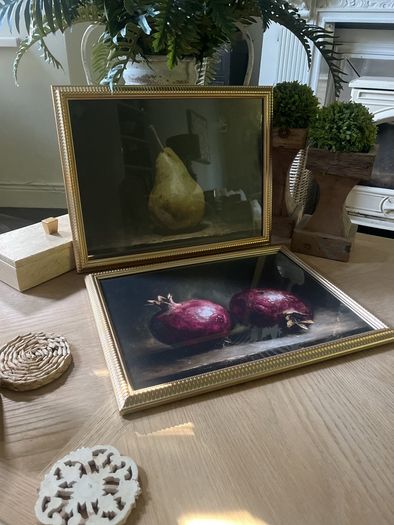Two gold framed fruit prints.