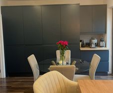 4 beige dining chairs and 2 counter stools