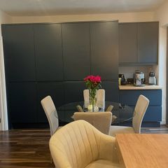 4 beige dining chairs and 2 counter stools