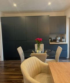 4 beige dining chairs and 2 counter stools