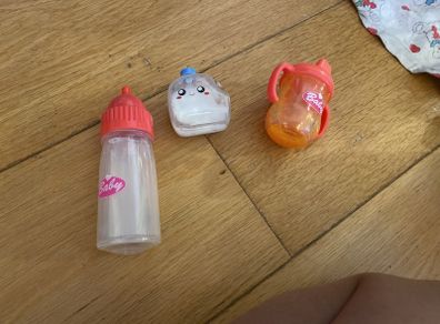 Toy feeding bottle with fake drinks