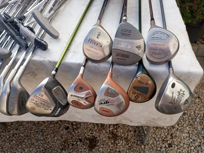 A selection of golf clubs and bags. All right handed clubs.