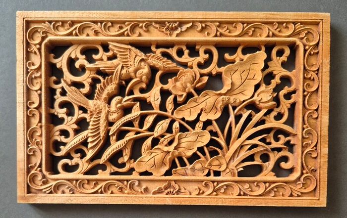 Carved decorative wooden panel, featuring birds.
