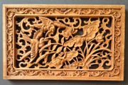 Carved decorative wooden panel, featuring birds.