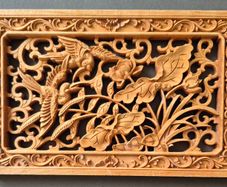 Carved decorative wooden panel, featuring birds.