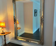 Large ornate wood/gold-effect wall mirror