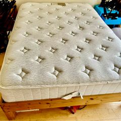 wooden double bed with mattress