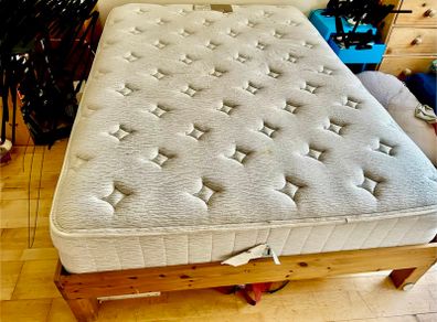 wooden double bed with mattress
