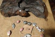This handmade necklace features a combination of ceramic floral beads and silver-toned metal beads on a pink cord.