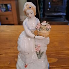 Vintage porcelain woman figurine detailed flowers