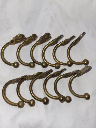 Patient brass coat hangers