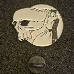 Skull, pin back badge.