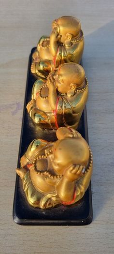 Three brass Buddha figurines