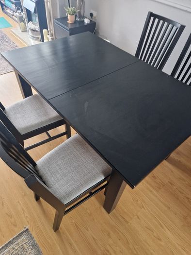 Black dining table with four chairs