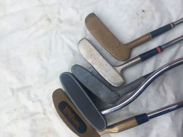 A selection of golf clubs and bags. Golf balls