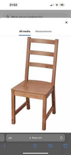 2 wooden chairs and a wall clock