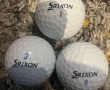 Three Srixon golf balls
