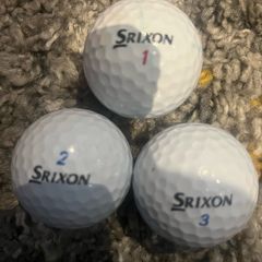 Three Srixon golf balls