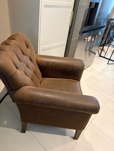 Pair of brown leather chesterfield armchairs