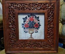 Flowers with carved wooden frame