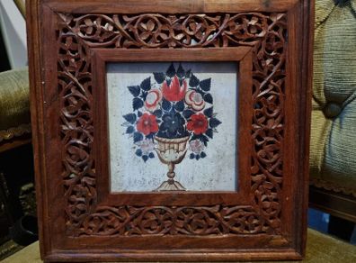 Flowers with carved wooden frame