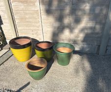 Four glazed green garden pots