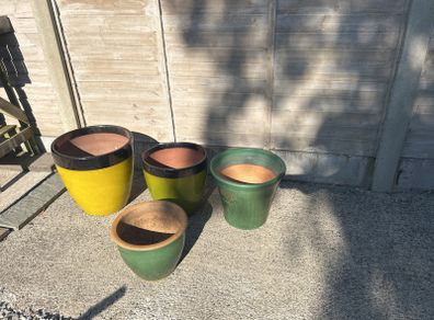 Four glazed green garden pots