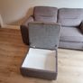 Grey two-seater sofa bed with matching storage footstool Image 9