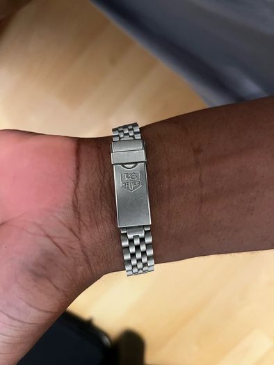 TAG HEUER WRIST WATCH, black dial with date, stainless steel bracelet strap, case ca. 34 mm