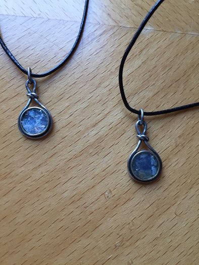 2 x silver pendants with vulcanic glass