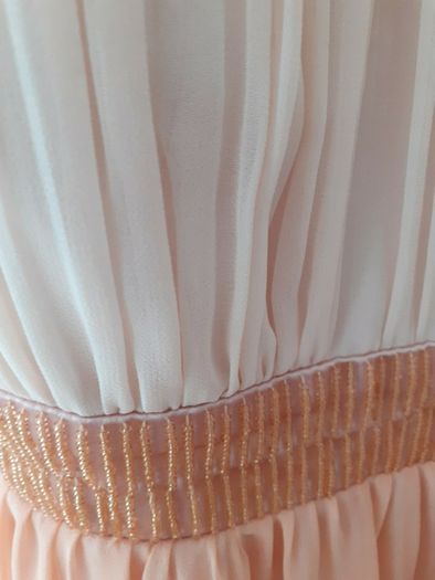 Occasional dress worn once and cleaned Slight emblishment on straps chest and waist .Slightly padded at bust so no need for a bra ..Knee length .25 euro paid 95 .