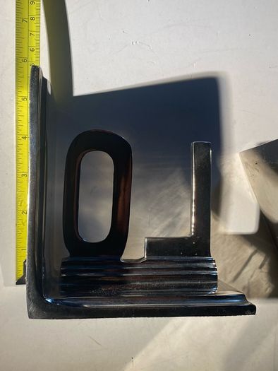 bookends made of cast metal likely aluminum that spell love