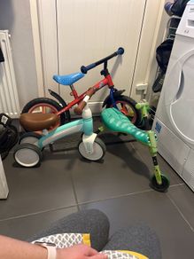 Two toddler bikes and a balance bike