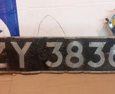 Vintage car number plate and aa badge