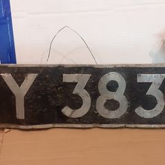 Vintage car number plate and aa badge