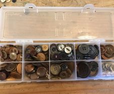 Box of assorted Brown/ grey buttons.