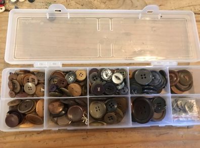 Box of assorted Brown/ grey buttons.