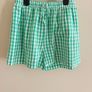 Marks and Spencers girls  green and white gingham shorts and tie-front top set. Image 3