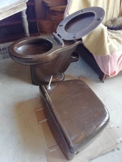 Cast iron brown bath with fittings, brown Royal Dalton toilet and cistern, brown wash hand basin with taps.
