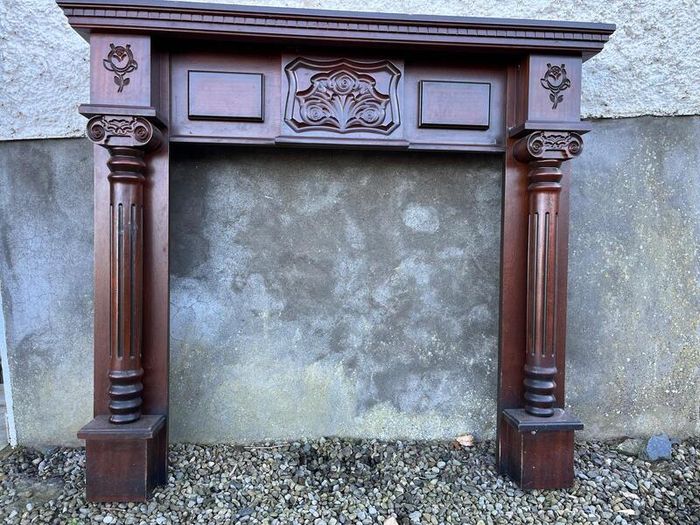 Wooden fireplace surround with carved details