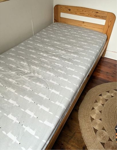 Single slatted wooden bed