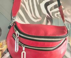 Red crossbody bag, adjustable shoulder strap.