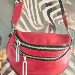 Red crossbody bag, adjustable shoulder strap.