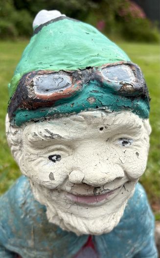 Vintage Reconstuted stone garden gnome on car, hand painted