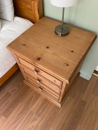Solid antique pine three-drawer bedside locker