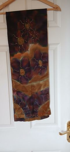 Hand painted, 100% silk scarf featuring a hand-rolled hem and custom metallic gutta detailing.