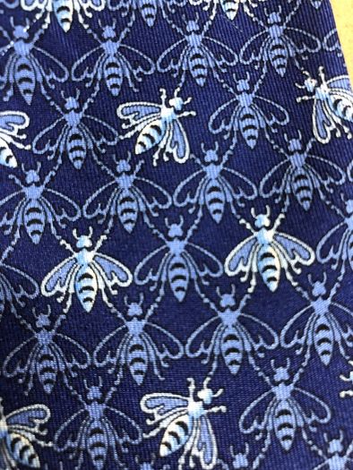 Designer silk tie in blues with bee pattern
